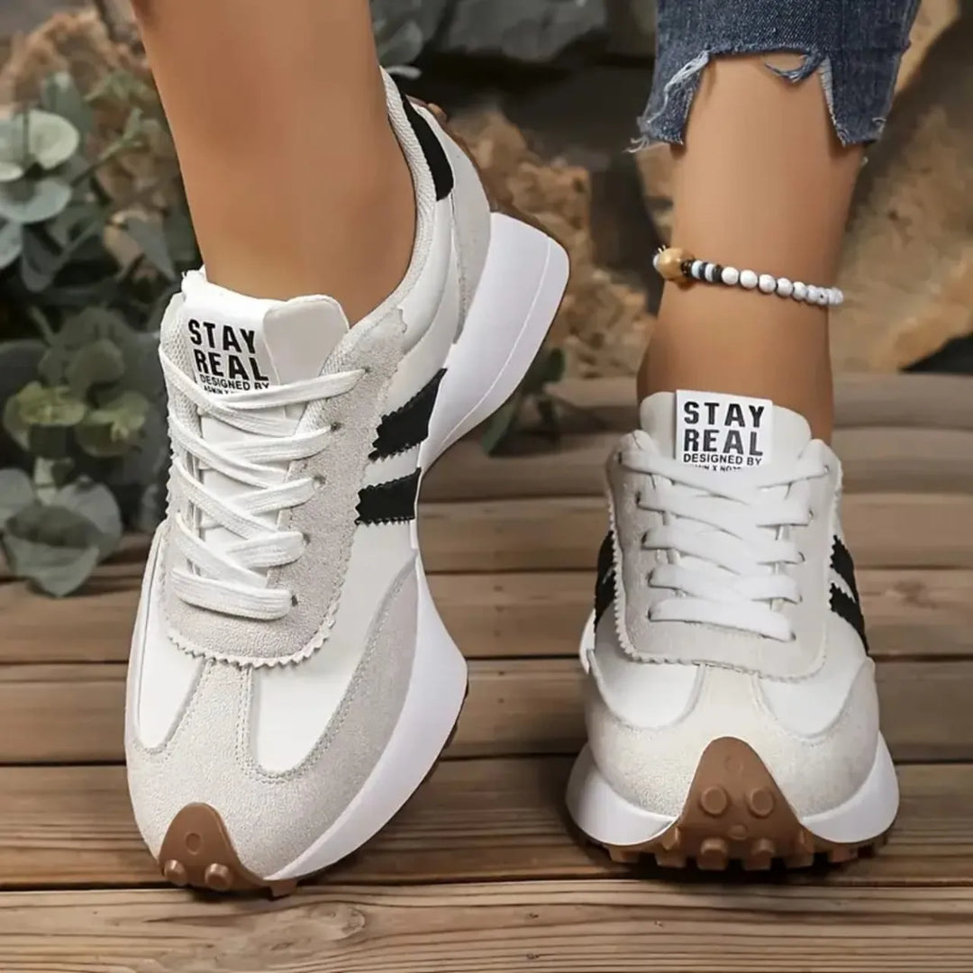 Fashionable women's platform sneakers with lace-up design. Comfortable casual footwear for stylish everyday wear.