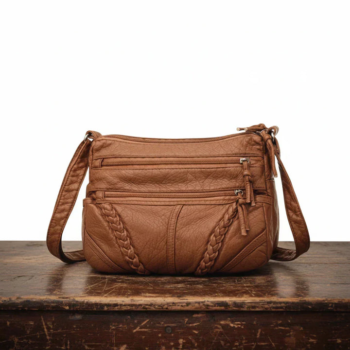 Classic women's leather crossbody bag, perfect for daily use and travel. A timeless and organized shoulder bag design.