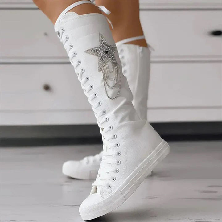Stylish women's lace-up boots with unique tassel details, essential footwear for fall/winter.