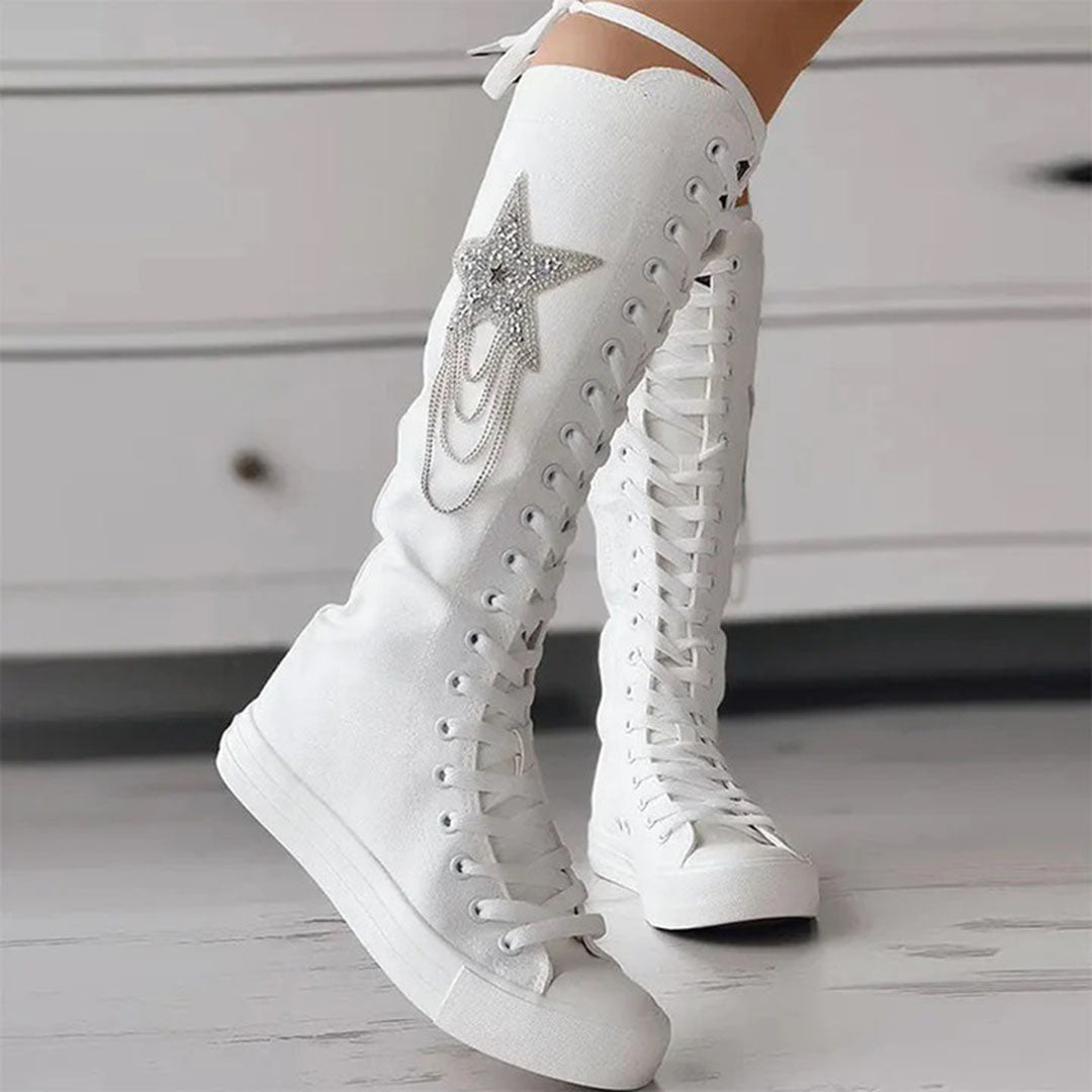Close-up of women's chic lace-up boots, highlighting tassels & durable sole for winter comfort.