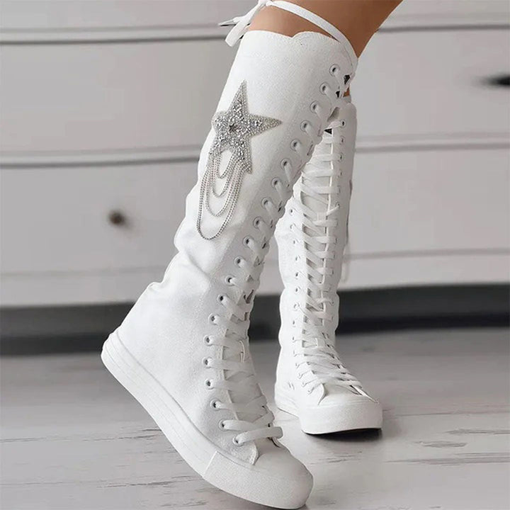 Close-up of women's chic lace-up boots, highlighting tassels & durable sole for winter comfort.