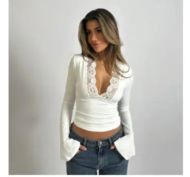 Close-up of the luxurious lace trim and soft fabric on a women's long-sleeve V-neck wrap top.