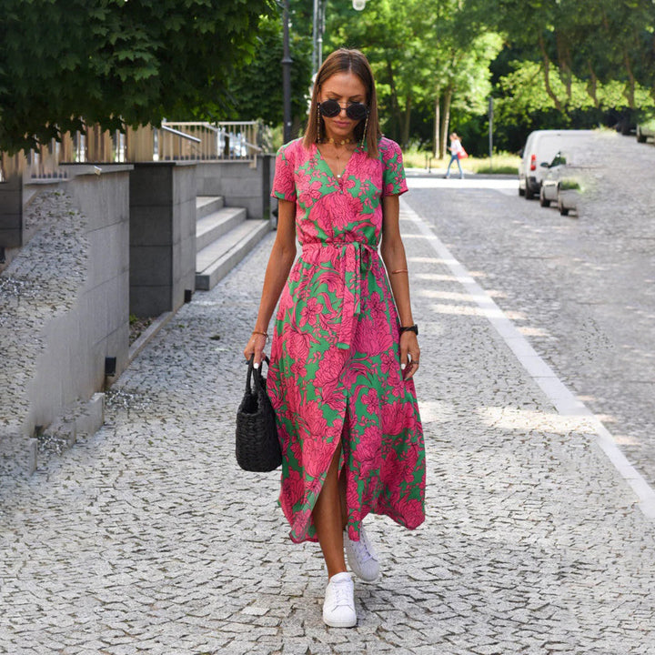Flowy women's floral print wrap midi dress, short sleeves, flattering silhouette. Ideal for summer.