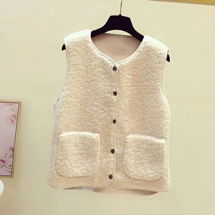 Soft women's V-neck sleeveless cardigan vest, designed with functional pockets & a button-front closure.