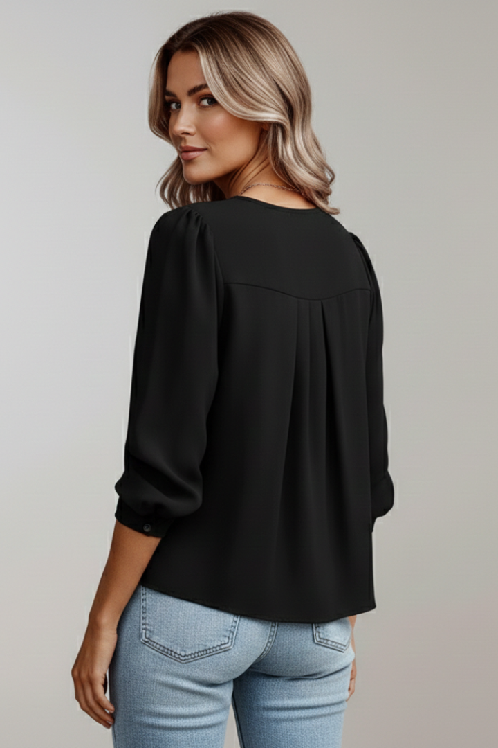 Elegant women's top; a stylish long-sleeve blouse with a round neck and chic puff sleeves.