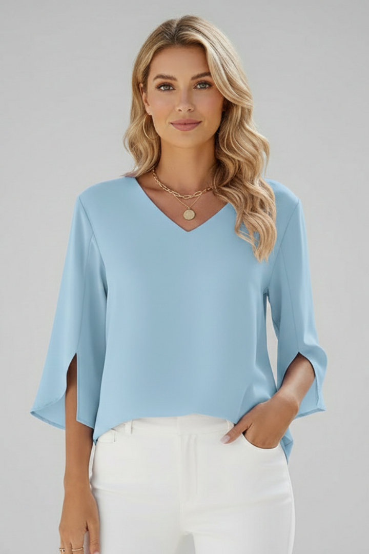 Relaxed fit women's V-neck pullover blouse, short sleeves, with pocket, designed for effortless style.