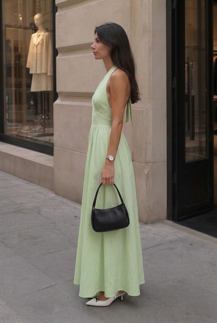 Flattering women's sleeveless A-line maxi dress. Features a v-neck halter & gathered bust for elegance.