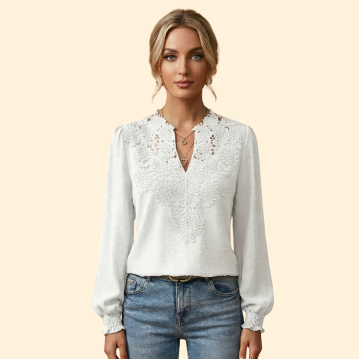 Elegant women's blouse featuring intricate lace and embroidery, a stylish and sophisticated ladies top.