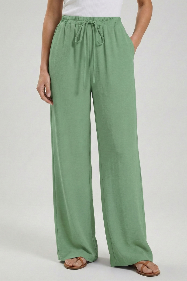 Relaxed fit women's palazzo trousers, featuring a comfortable drawstring waist, wide leg & pockets.
