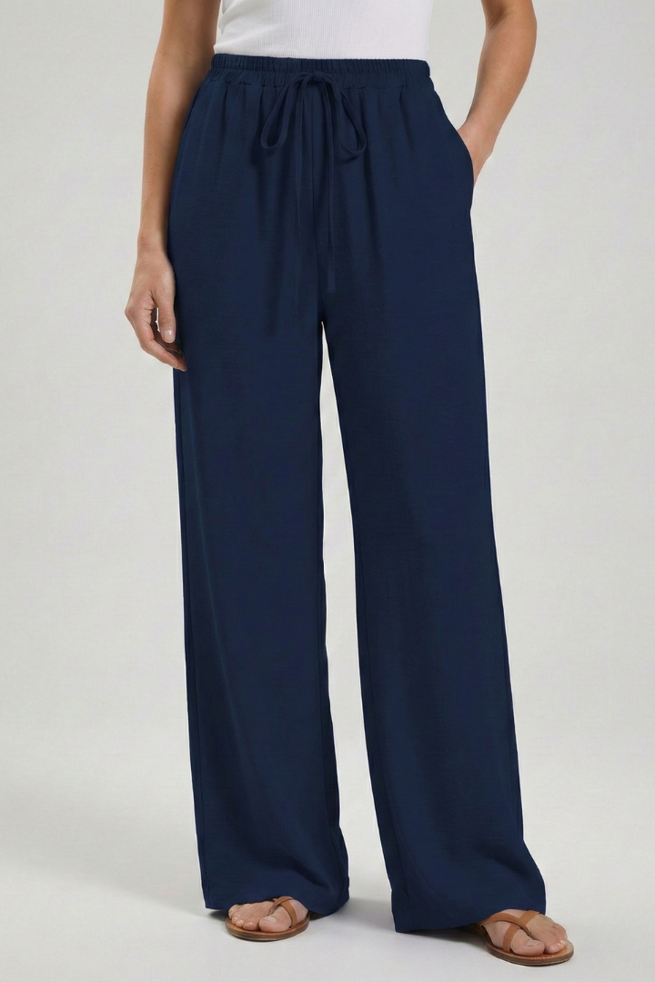 Trendy women's palazzo trousers; flowing wide leg, drawstring, and essential pockets for style & comfort.