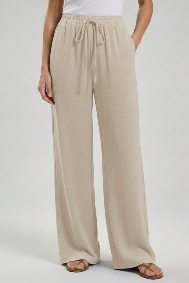Summer women's flowing palazzo trousers with comfortable wide leg, drawstring, & pockets.