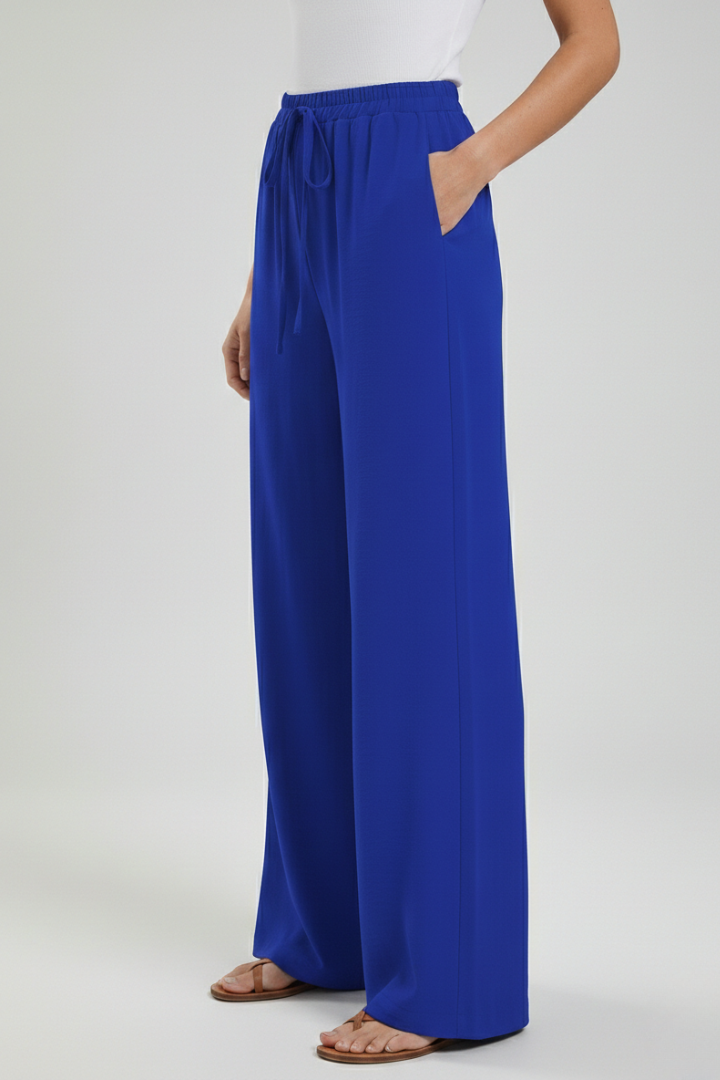 Stylish women's flowing palazzo trousers, perfect for casual summer fashion with handy pockets.