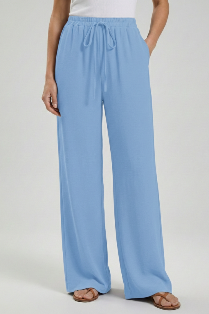 Women's palazzo trousers: drawstring waist, deep pockets, & elegant wide leg design.