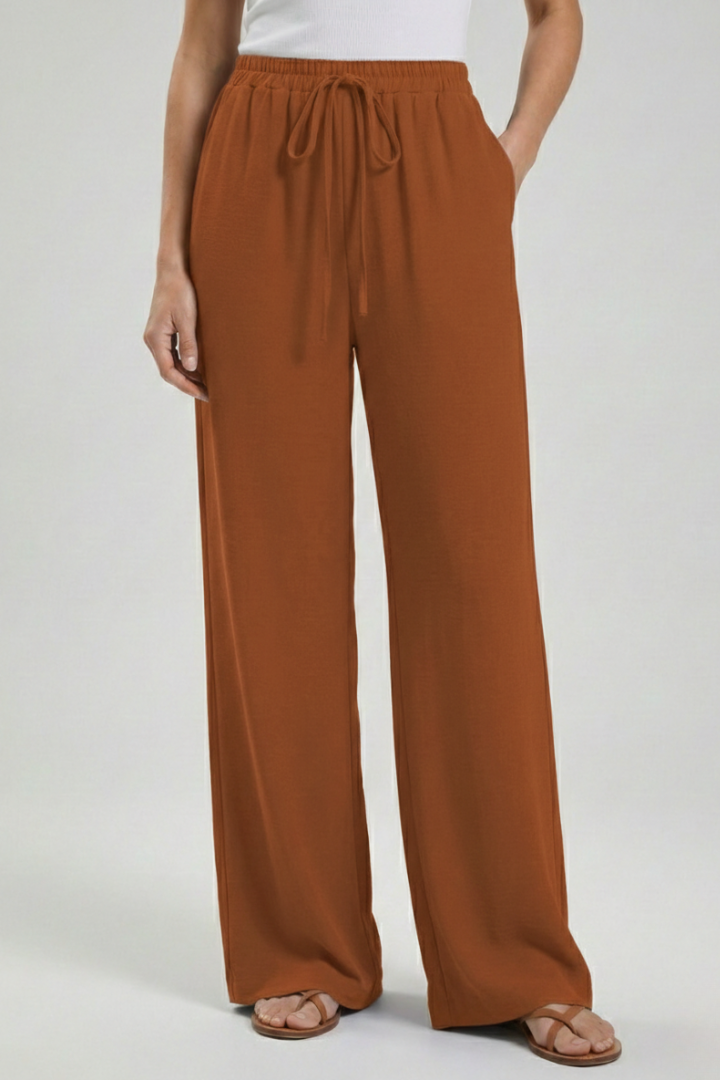 Flowing wide-leg palazzo trousers for women, with adjustable drawstring waist and practical pockets.