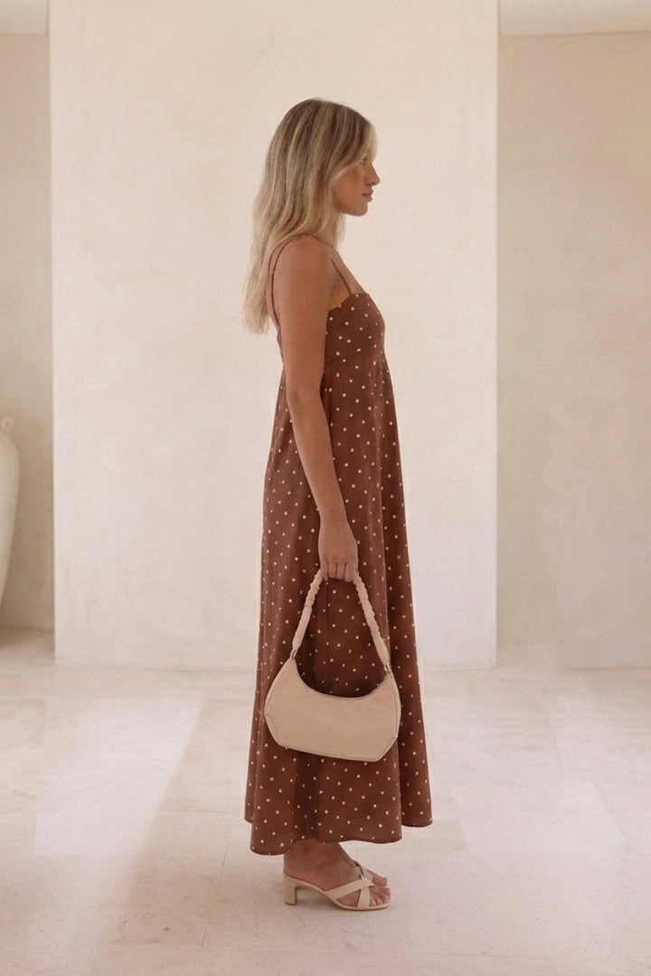 Elegant sleeveless polka dot maxi dress for women, flowy & comfortable, ideal for summer day or vacation.