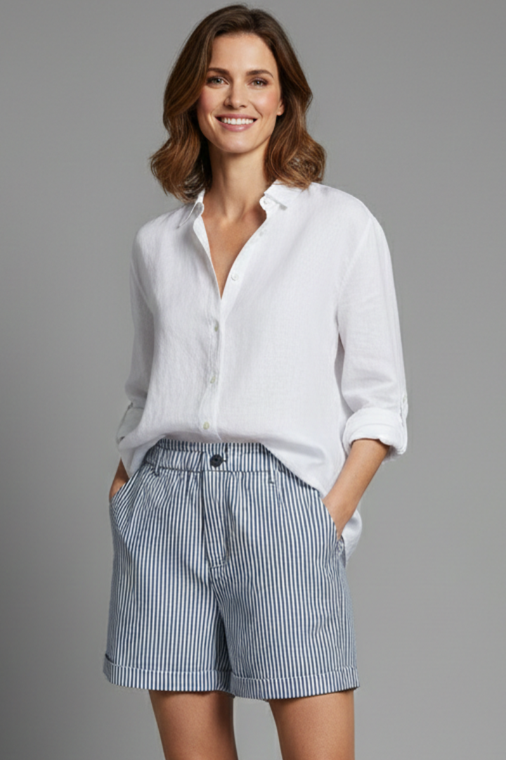 Close-up of women's tailored high-waist striped shorts, showcasing fabric and button detail. Ideal for summer.