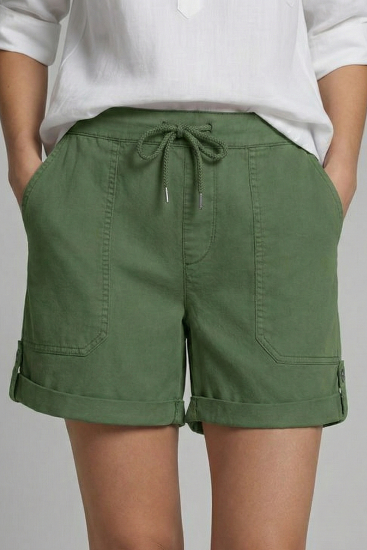 Product shot: neatly folded women's casual drawstring pocket shorts, ready for warm weather & travel.