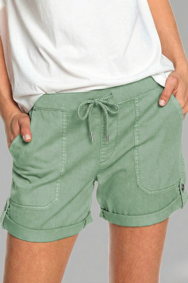 Woman wearing comfy casual drawstring pocket shorts, showcasing relaxed fit for warm weather activities.