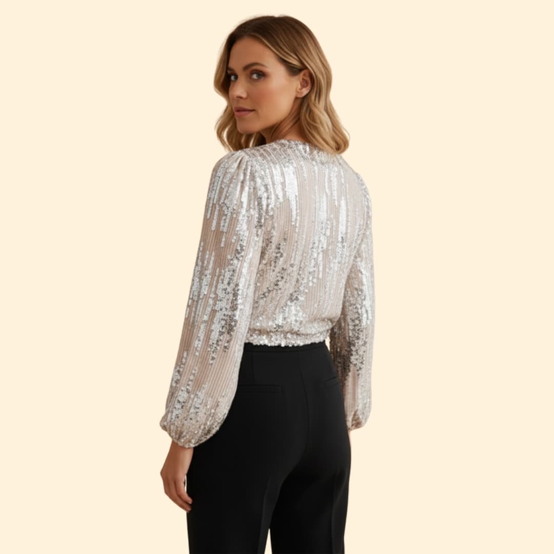 Glamorous women's sequin wrap blouse, featuring sparkling gold sequins, a v-neck, and long sleeves for evening.