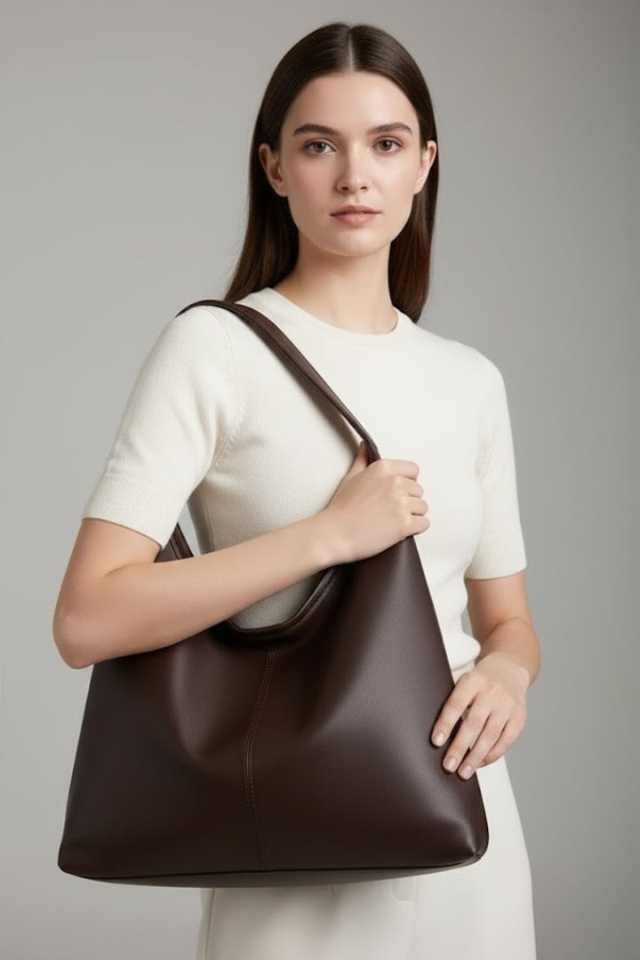 Black faux leather tote bag for women, classic design with spacious interior, ideal for work.