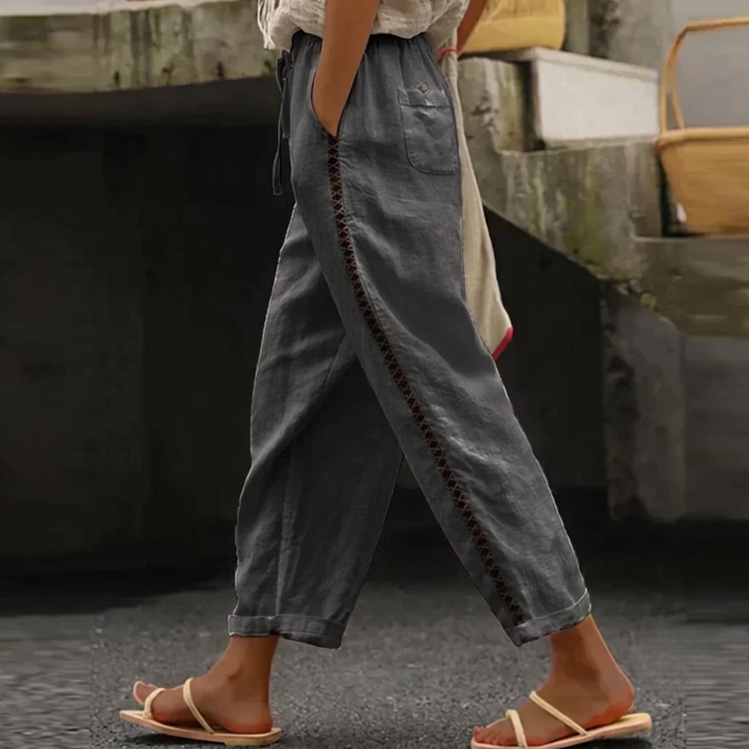 Fashionable women's high waist striped pants, ideal for summer; their tapered leg creates an effortlessly chic silhouette.