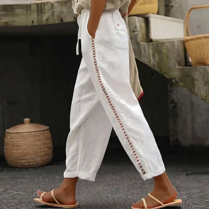 Women's high waist striped trousers with a tapered ankle-length leg, perfect for chic casual or business casual looks.