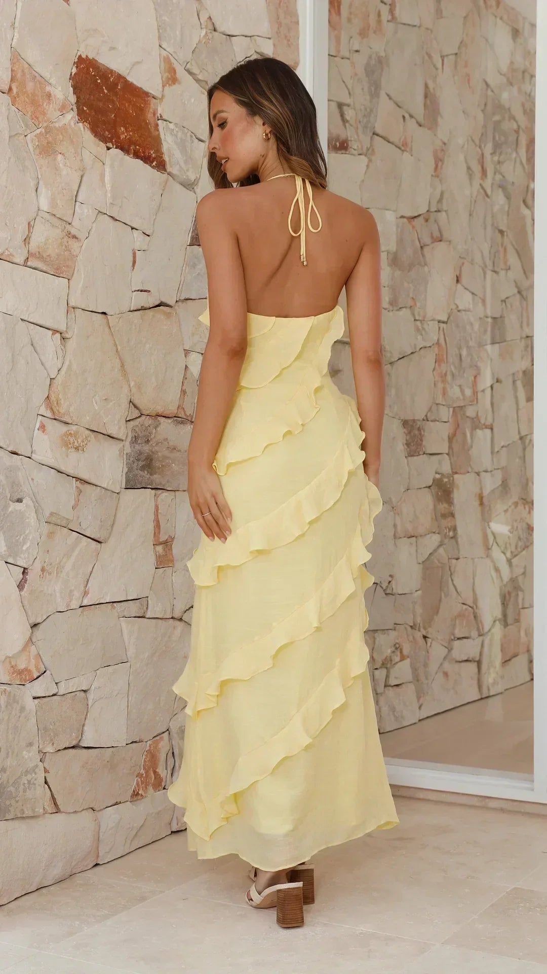 Chic women's sleeveless tiered maxi dress with halter neckline & ruffles, ideal for elegant events.