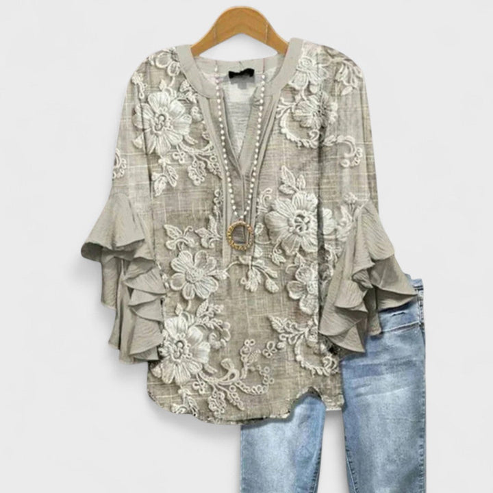 Boho chic women's blouse, vibrant floral print, elegant ruffle flare sleeves, and a flattering flowy fit.