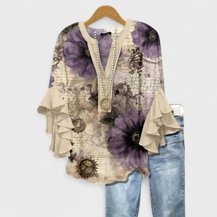 Summer style women's blouse, pretty multicolor floral print, flowy fit, and chic ruffle flare sleeves.