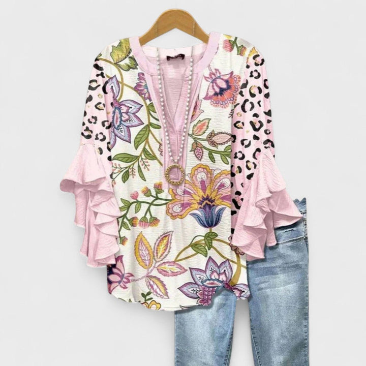 Stylish women's floral print blouse, soft flowy fabric, long ruffle flare sleeves, perfect for a boho summer outfit.