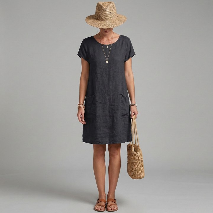 Women's effortless relaxed mini shift dress with short sleeves, round neck & patch pockets. Perfect for casual summer.