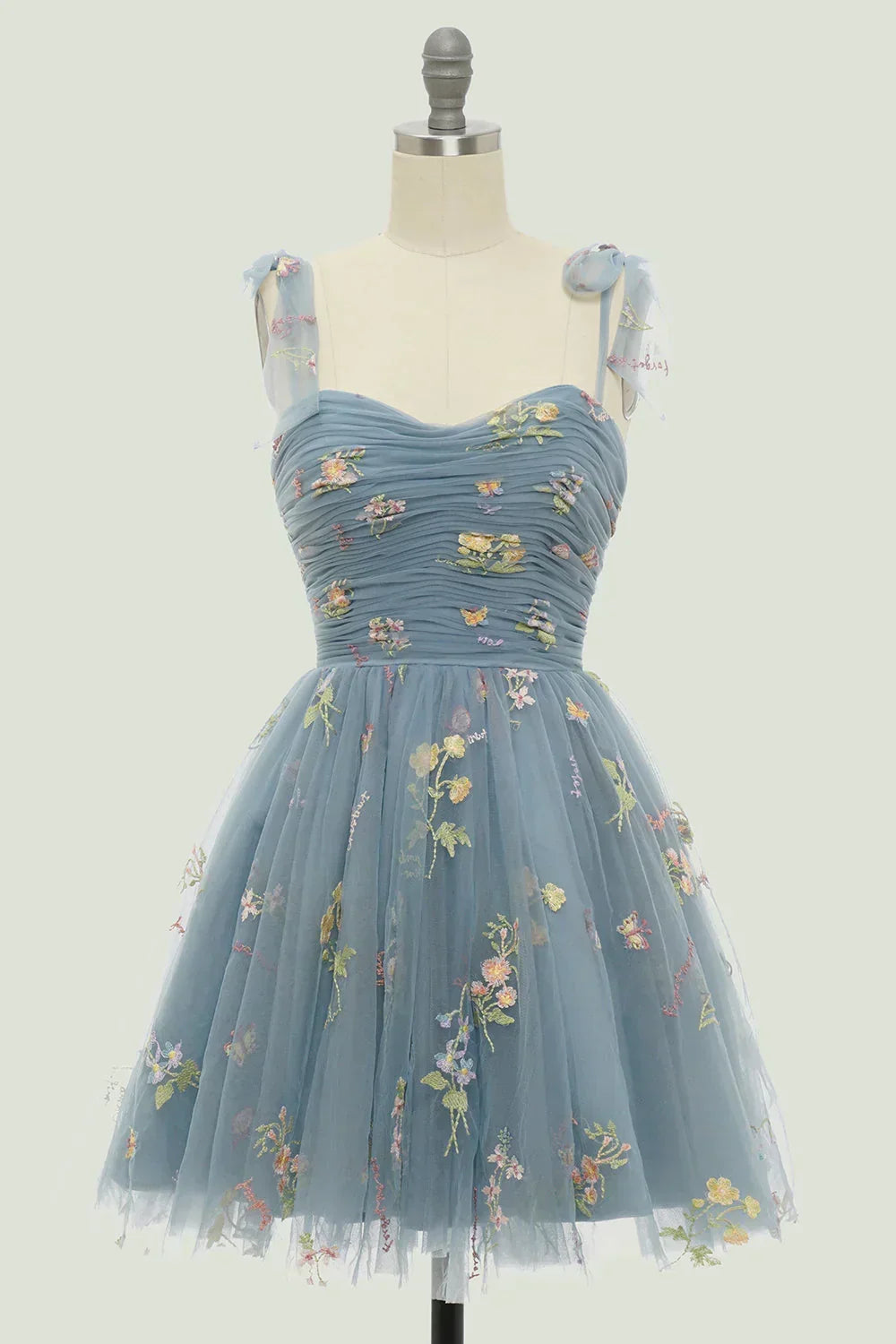 Women's stylish floral embroidered mini dress. Elegant layered skirt design, ideal for summer parties & cocktails.