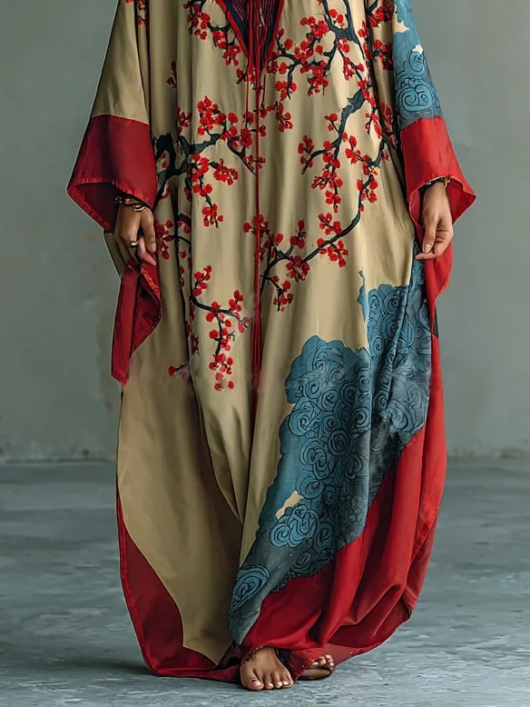 Red batwing maxi dress for women featuring a beautiful Japanese plum blossom print. Versatile for beach to holiday.