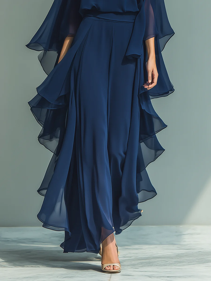 Fashionable women's elegant two-piece outfit with flared sleeves & ruffled accents on a sophisticated pant set.
