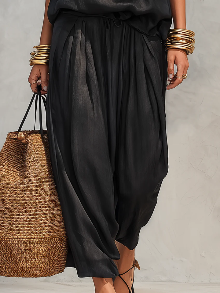 Chic women's draped two-piece set, perfect for summer. Includes a flowing top & comfortable wide-leg pants.