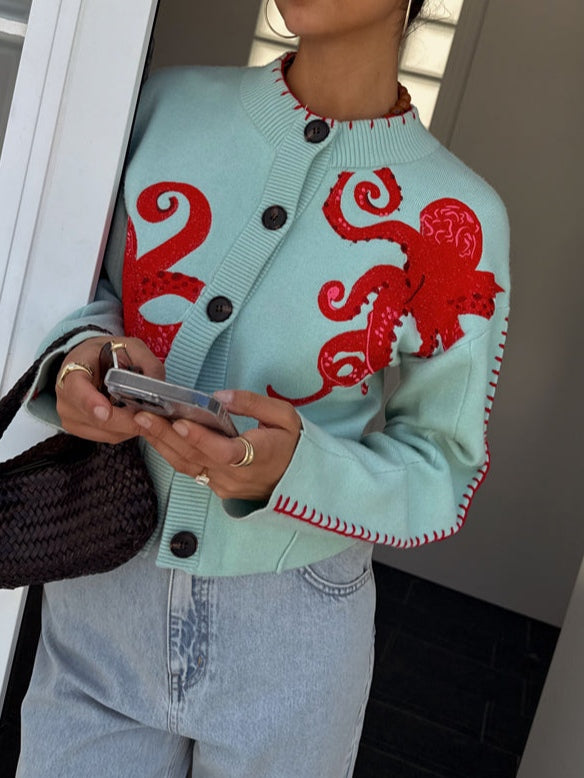 Versatile women's light blue octopus knit cardigan. Long sleeve, button front graphic sweater for unique casual style.