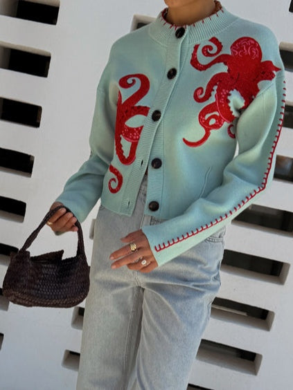 Cozy women's light blue animal print cardigan. Octopus knit graphic sweater, long sleeve, button front for casual style.