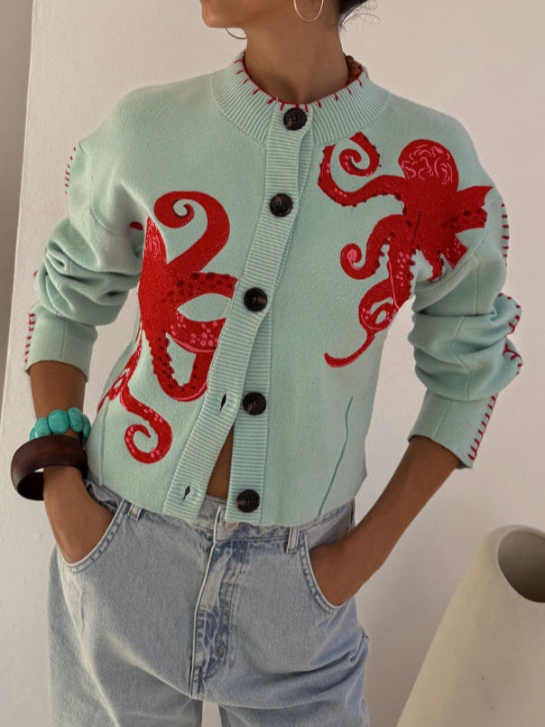 Light blue women's knit cardigan with unique octopus pattern. Button front, long sleeve, cozy casual wear.