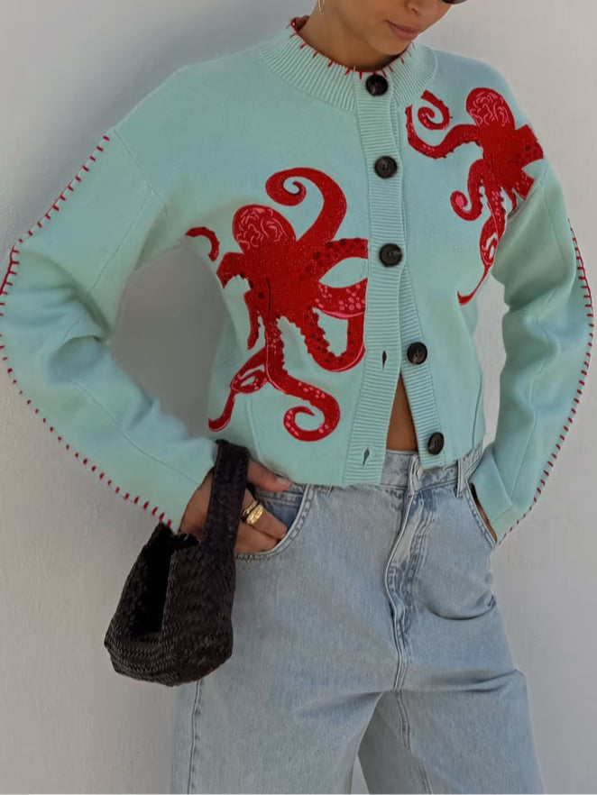 Women's long sleeve light blue cardigan featuring an octopus pattern, button front, and soft knit for cozy layering.