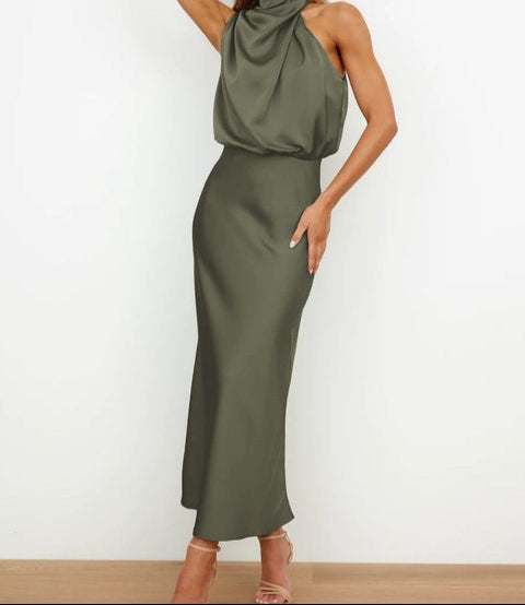 Flowy long summer halter neck dress in elegant fabric, ideal for women's special occasion wear.