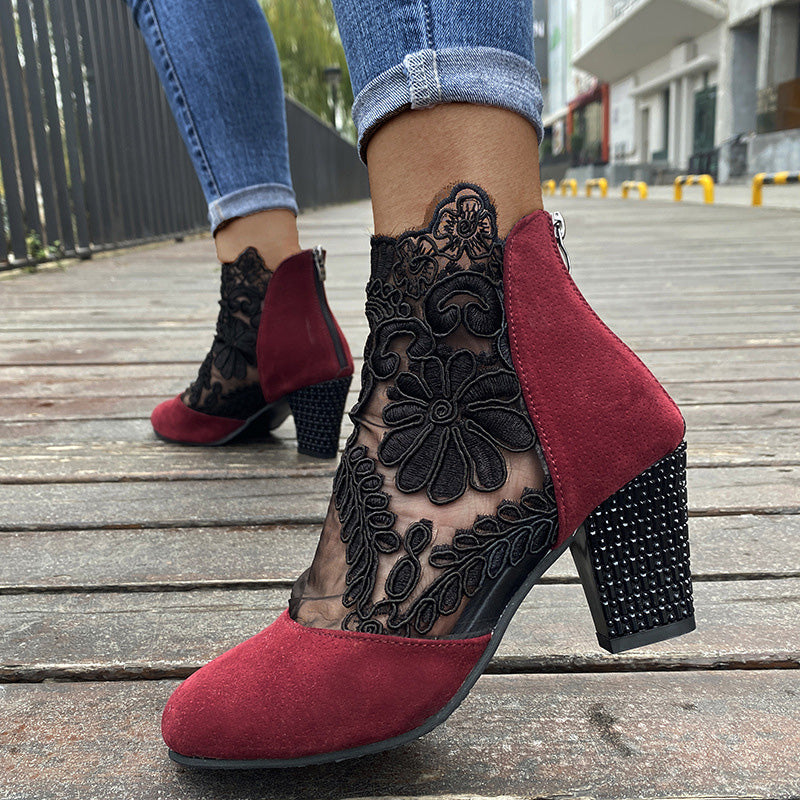 Stylish women's dress boots featuring intricate lace embroidery and a sturdy block heel for an elegant look.