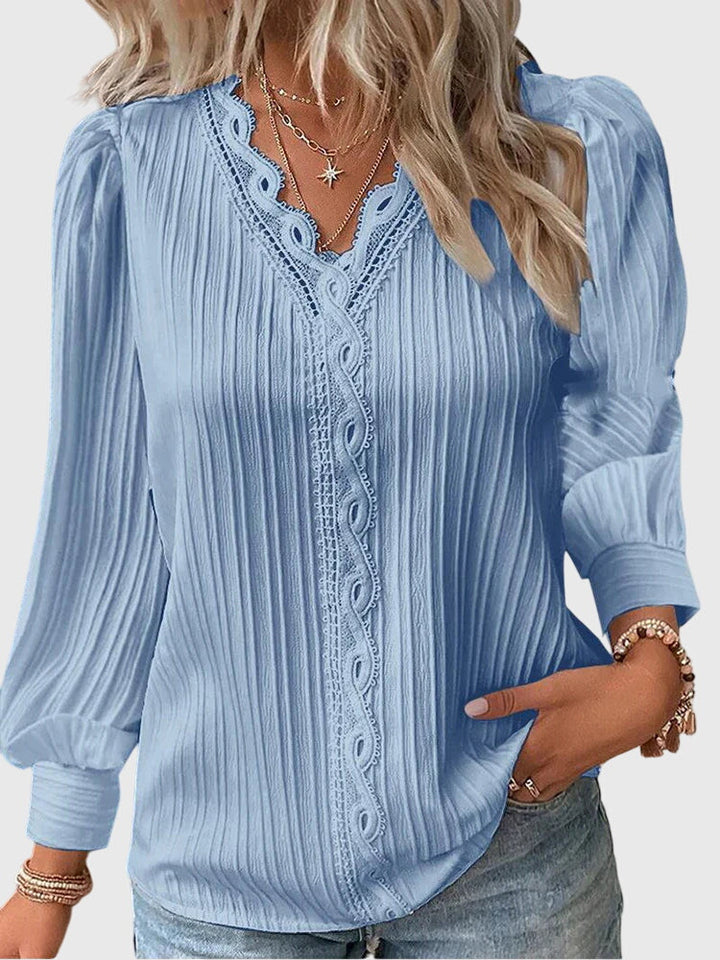 Versatile women's long sleeve pullover blouse. Essential round neck top for elegant casual and office wear.