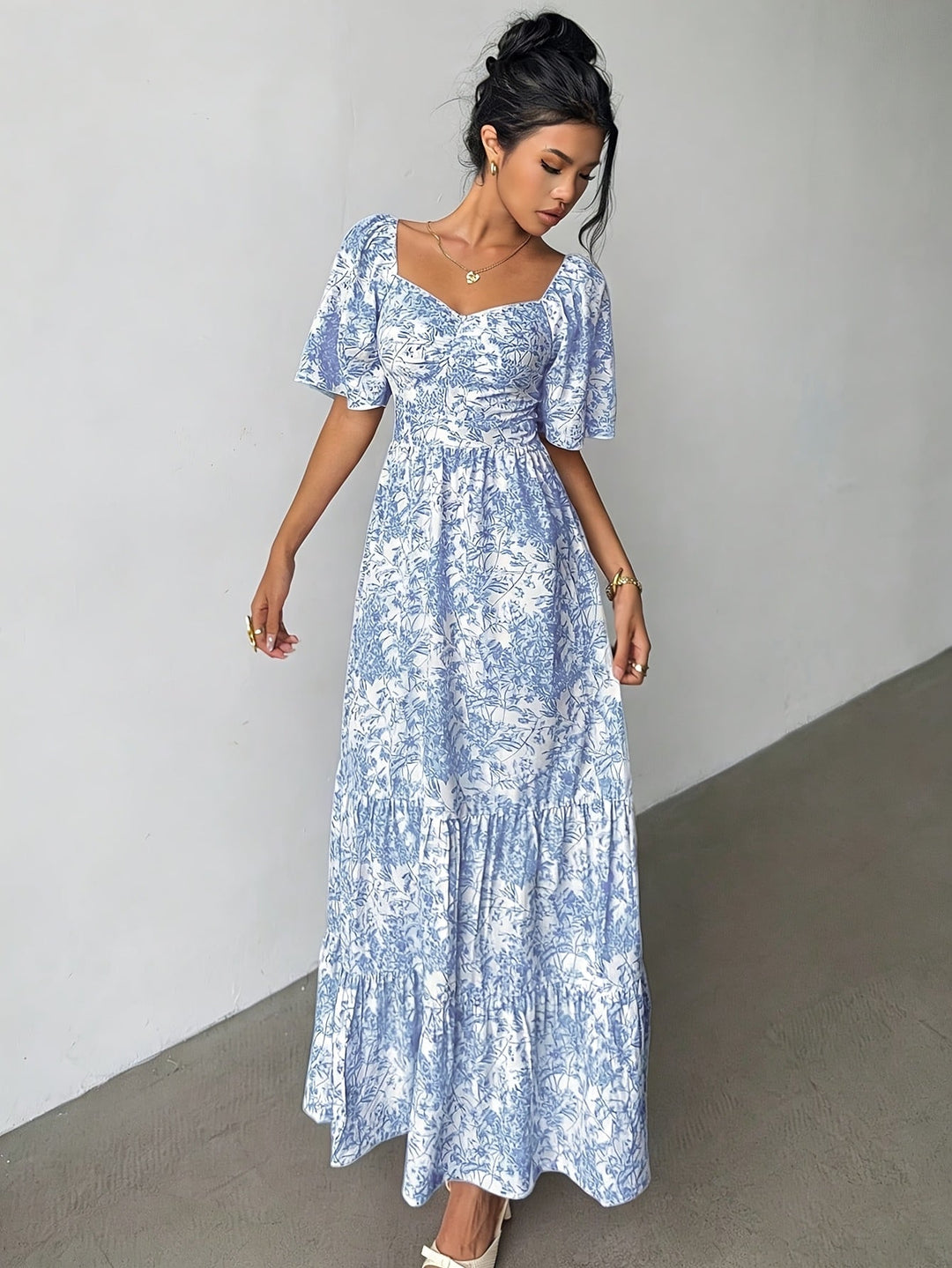 Stylish pink floral maxi dress for ladies, with a flattering sweetheart neck & comfortable tiered design.