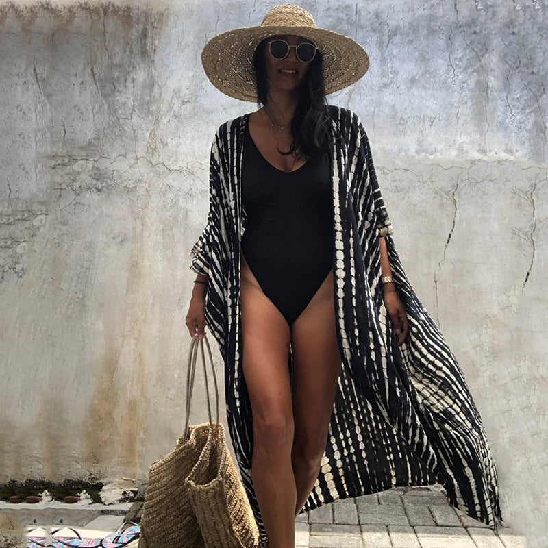 Glamorous women's beach cover up, sun protection resort wear for elegant summer style.