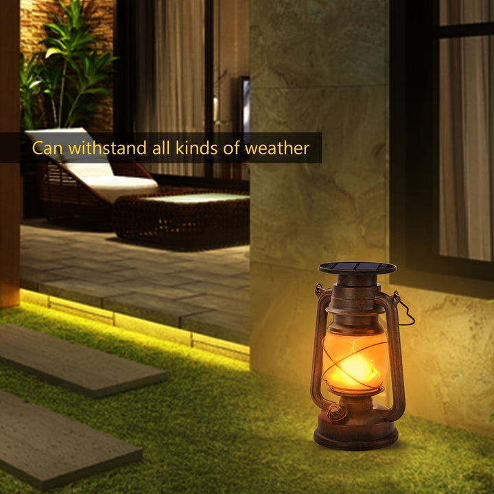 Vintage solar lantern pair illuminating a garden path with warm flickering LED flames. Weather resistant decor.