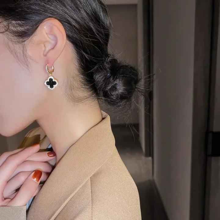 Symbolic lucky clover earrings, gold-plated and crystal-studded, designed for women's elegant everyday wear.