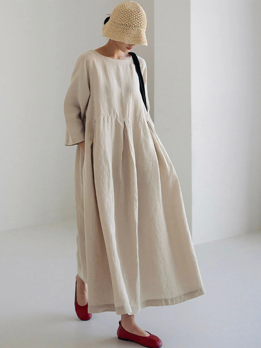 Women's relaxed fit tiered maxi dress with long sleeves, round neck, and side pockets, perfect for casual wear.