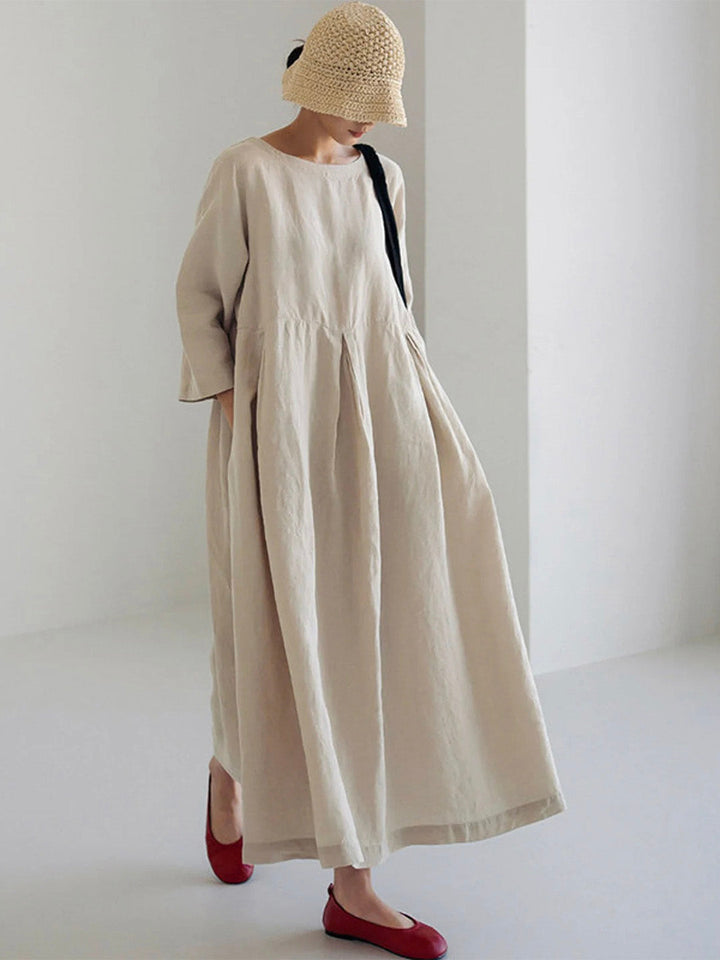 Women's relaxed fit tiered maxi dress with long sleeves, round neck, and side pockets, perfect for casual wear.