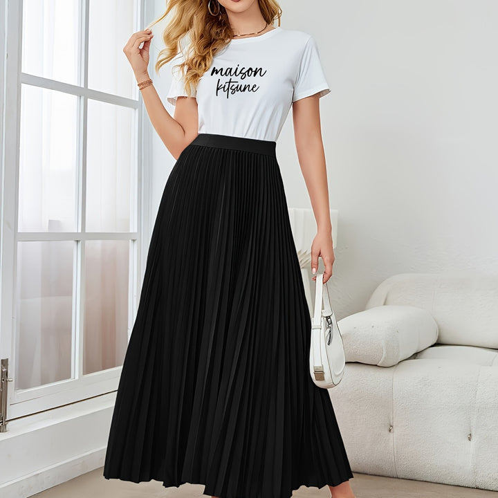 Model wearing a solid color pleated midi skirt, showcasing its flowy A-line cut & elegant elastic waist.