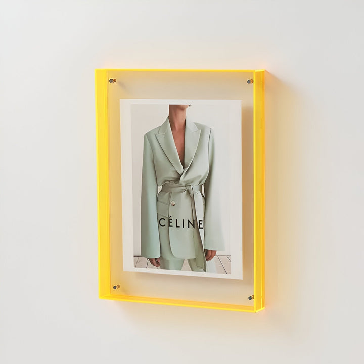 Versatile clear frame standing on a desk, perfect for displaying portraits or small artworks.
